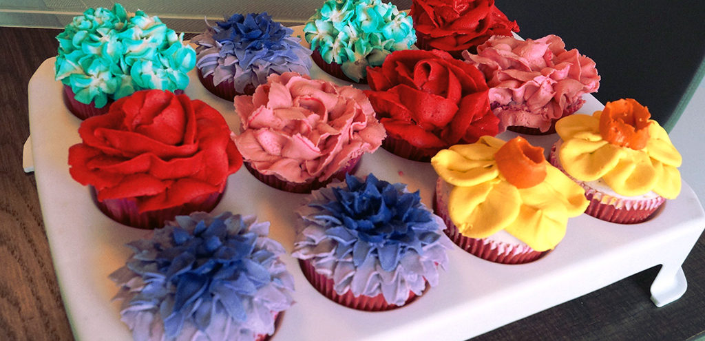 Cupcakes frosted with colourful flower shapes