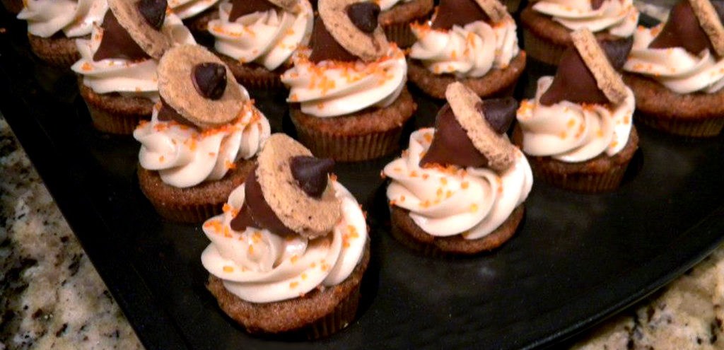 Frosted cupcakes topped with confectionery acorns