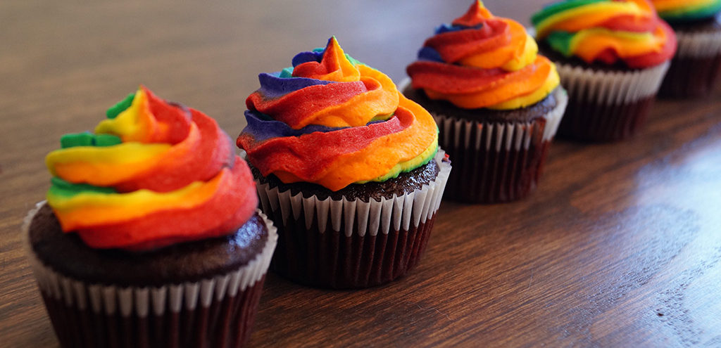 Cupcakes topped with a swirl of rainbow frosting