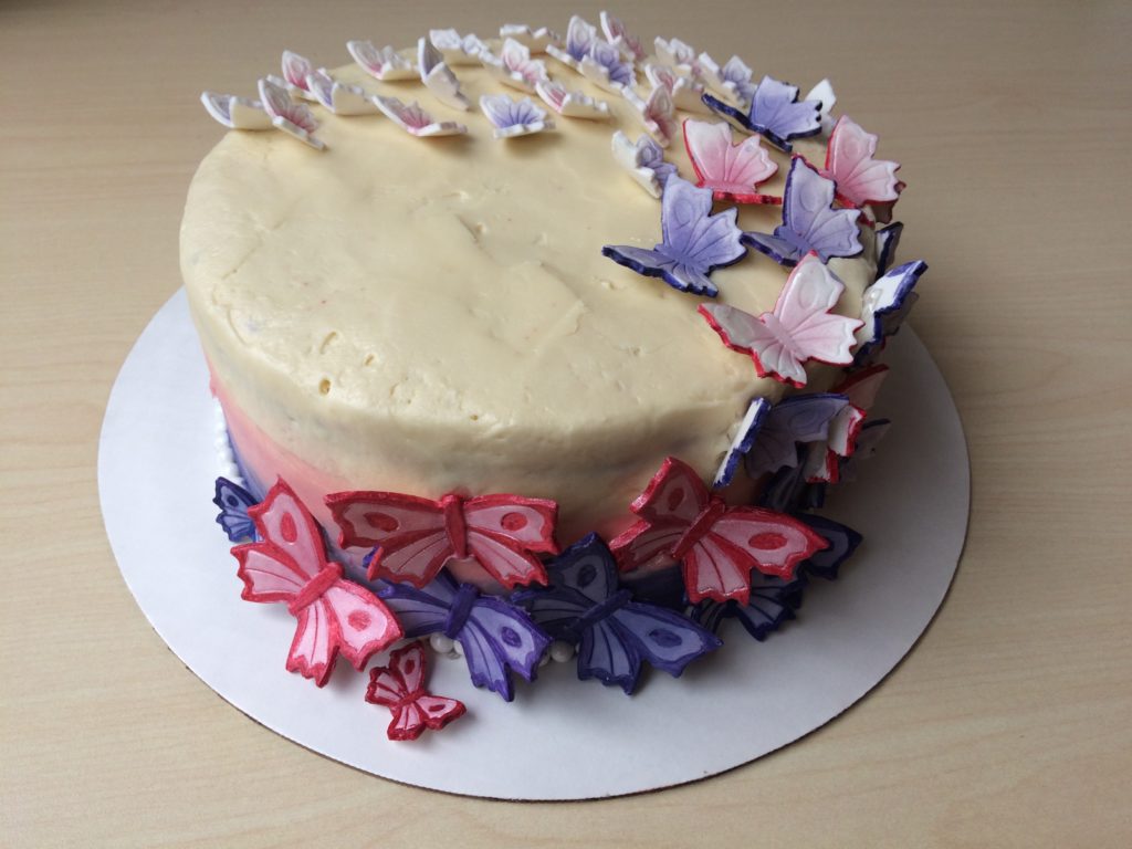 purple and pink sugar butterflies on wedding cake